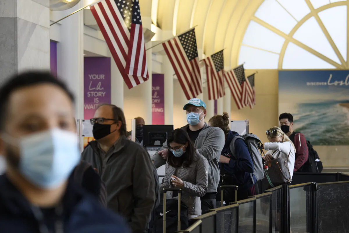 Passengers wait in line to enter a Transportation Security Administration checkpoint at Los Angeles International Airport, in Los Angeles, Calif., Nov. 25, 2020. (PATRICK T. FALLON/AFP via Getty Images)