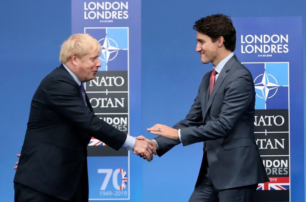 British Prime Minister Boris Johnson, left, welcomes Canadian Prime Minister Justin Trudeau during official arrivals for a NATO leaders meeting at The Grove hotel and resort in Watford, Hertfordshire, England on Dec. 4, 2019. (AP Photo/Francisco Seco, File)