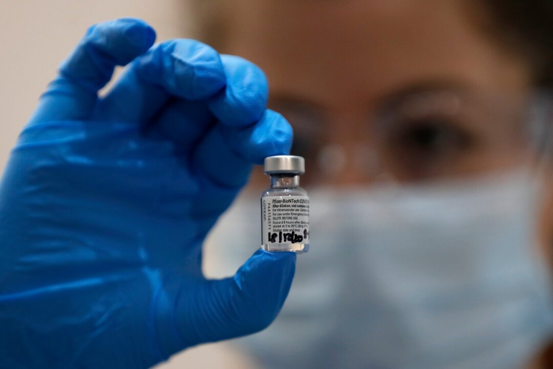 A nurse holds a vial of the Pfizer-BioNTech COVID-19 vaccine at Guy's Hospital in London, on Dec. 8, 2020. (Frank Augstein/AP Photo)