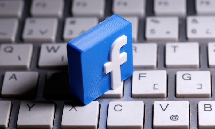 A 3D-printed Facebook logo is seen placed on a keyboard in this illustration taken March 25, 2020. (Dado Ruvic/Illustration)