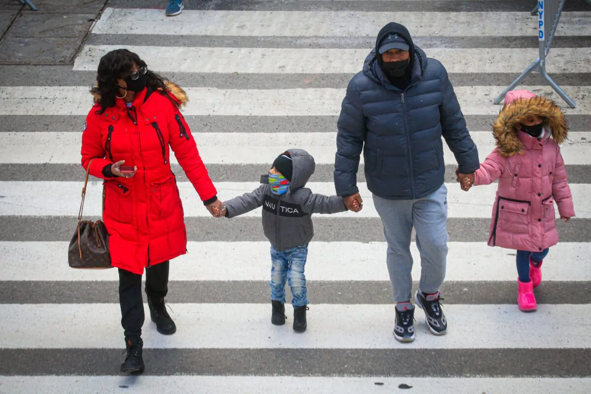 People wear face masks as they visit Times Square in New York on Dec. 10, 2020. (KENA BETANCUR/AFP via Getty Images)