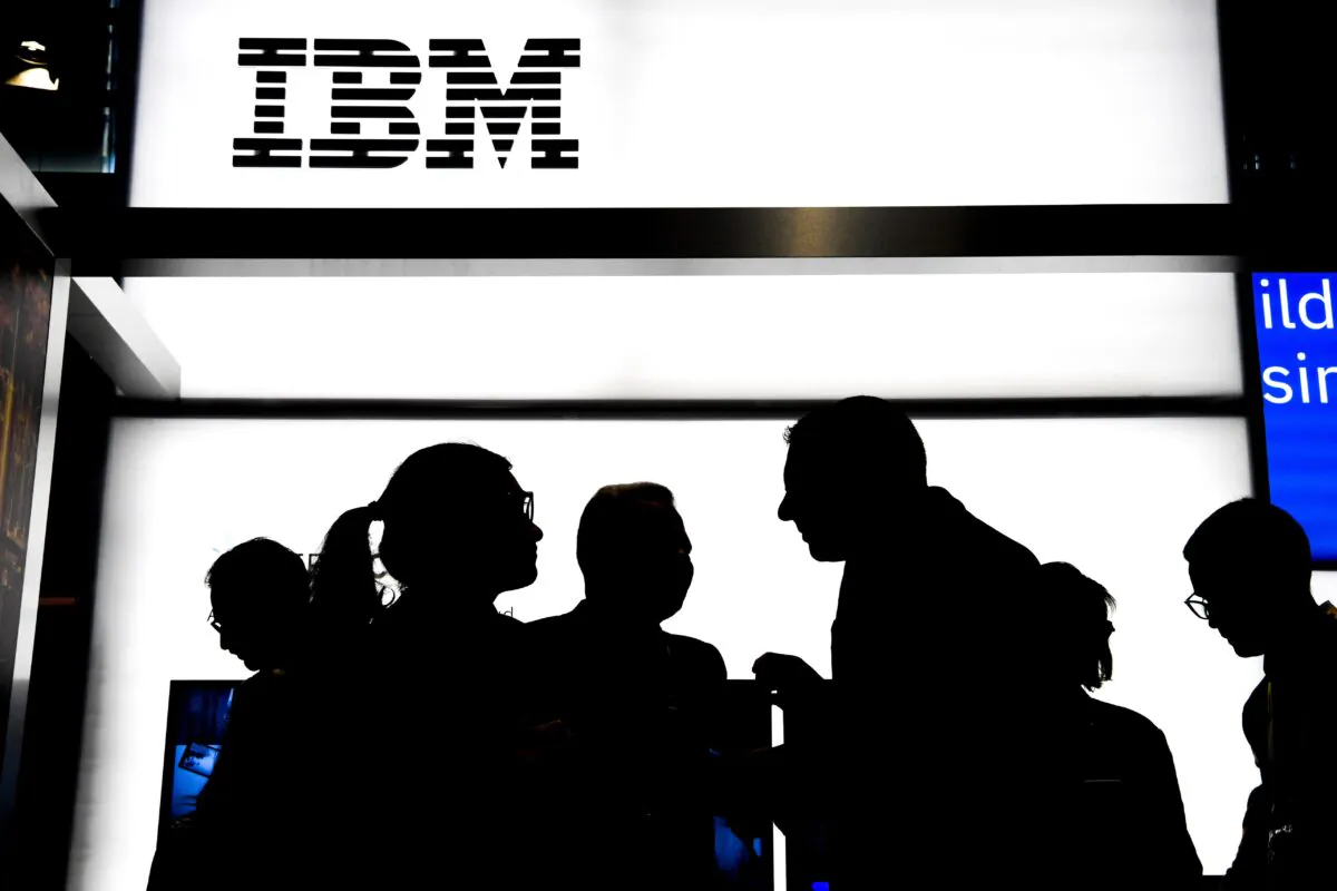 People talk at the stand of the US multinational information technology company International Business Machines Corporation (IBM), during the Vivatech startups and innovation fair, in Paris on May 16, 2019. (Alain Jocard/AFP via Getty Images)