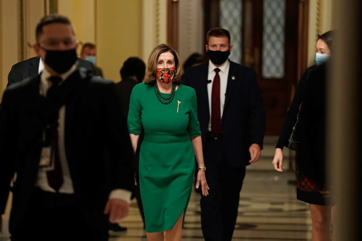 Speaker of the House Nancy Pelosi (D-Calif.), walks from the Senate floor as both chambers of Congress are aimed to pass the coronavirus disease (COVID-19) package in a marathon session on Capitol Hill Washington, on Dec. 21, 2020. (Ken Cedeno/Reuters)