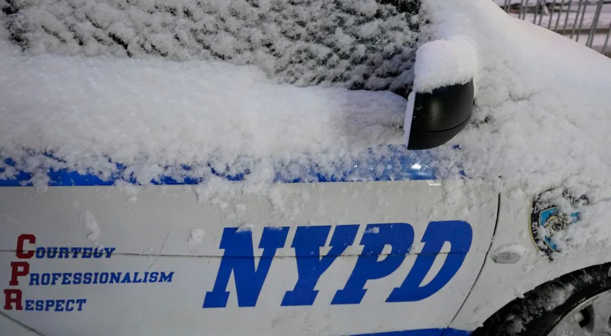 A NYPD police car is seen in the snow in New York, on Dec. 17, 2020. (Timothy A. Clary/AFP via Getty Images)
