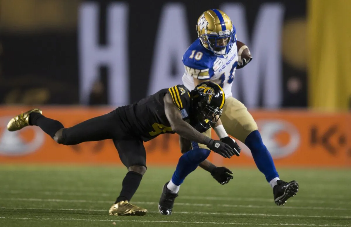 Hamilton Tiger-Cats' Richard Leonard tackles Winnipeg Blue Bombers' Nic Demski during the 107th Grey Cup in Calgary on Nov. 24, 2019. (The Canadian Press/Todd Korol)