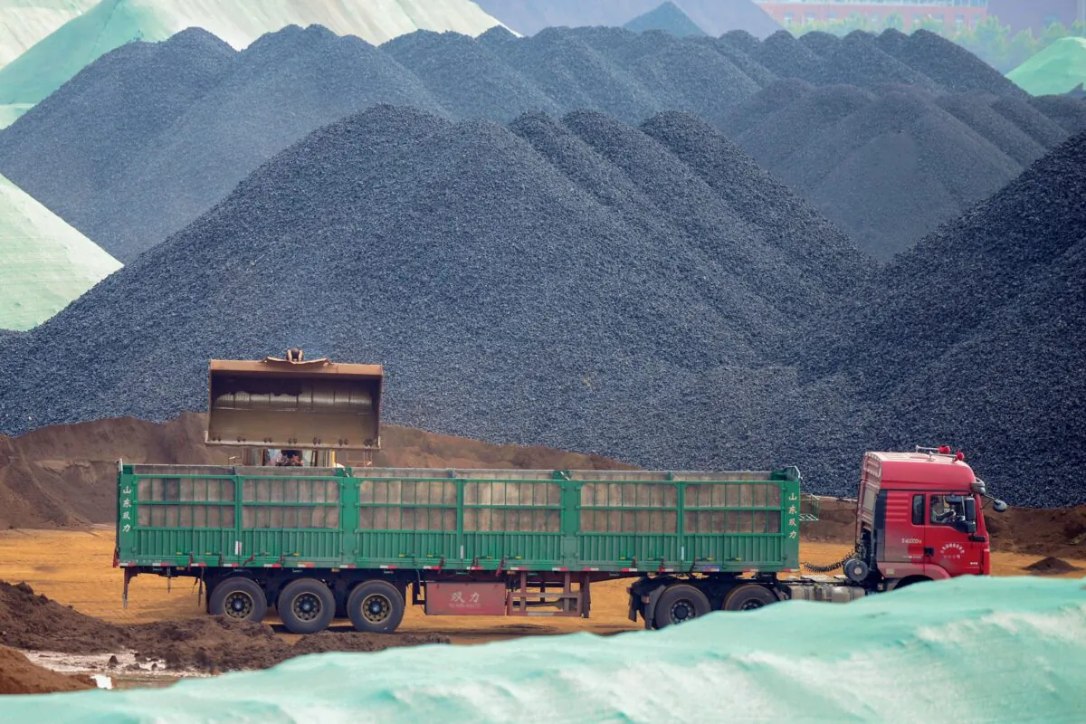 This photo taken on May 15, 2019 shows a truck transferring imported iron ore at a port in Rizhao in China's eastern Shandong province. (STR/AFP via Getty Images)