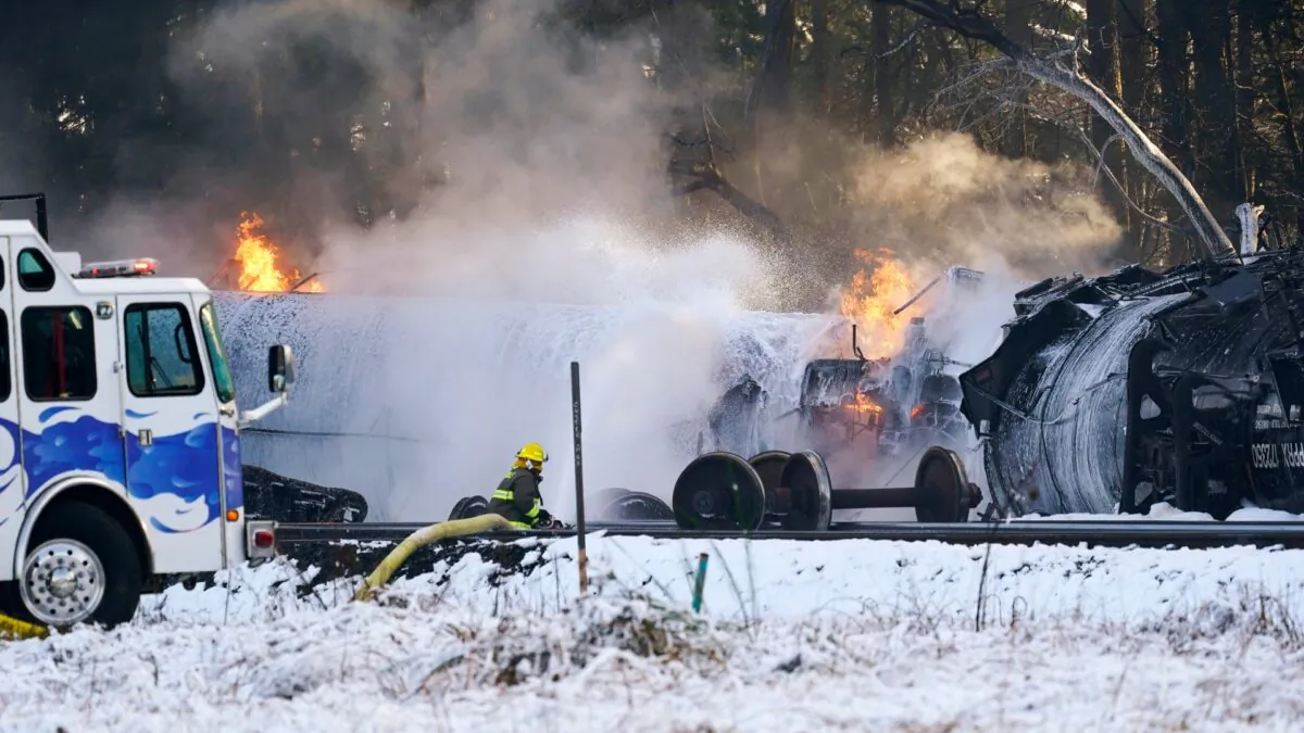 A firefighter sprays foam on burning, derailed train cars in Custer, Wash., on Dec. 22, 2020. (Elaine Thompson/AP Photo)
