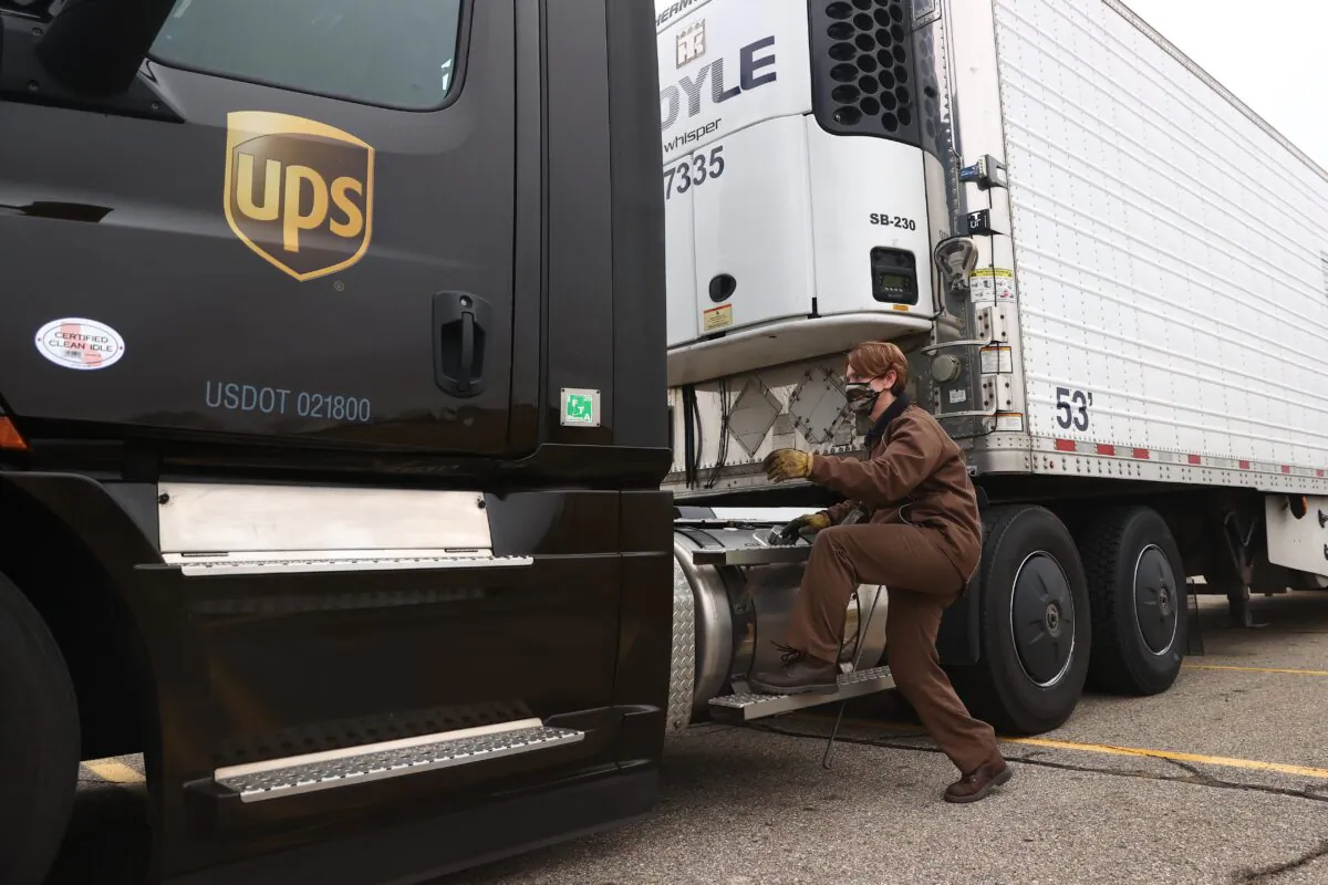 A UPS worker hooks a UPS truck to a trailer containing shipments of the Pfizer And BioNTech COVID-19 vaccine at the Capital Region International Airport on December 13, 2020 in Lansing, Michigan. The first doses of the coronavirus (COVID-19) vaccine will be distributed to all 50 states. (Rey Del Rio/Getty Images)