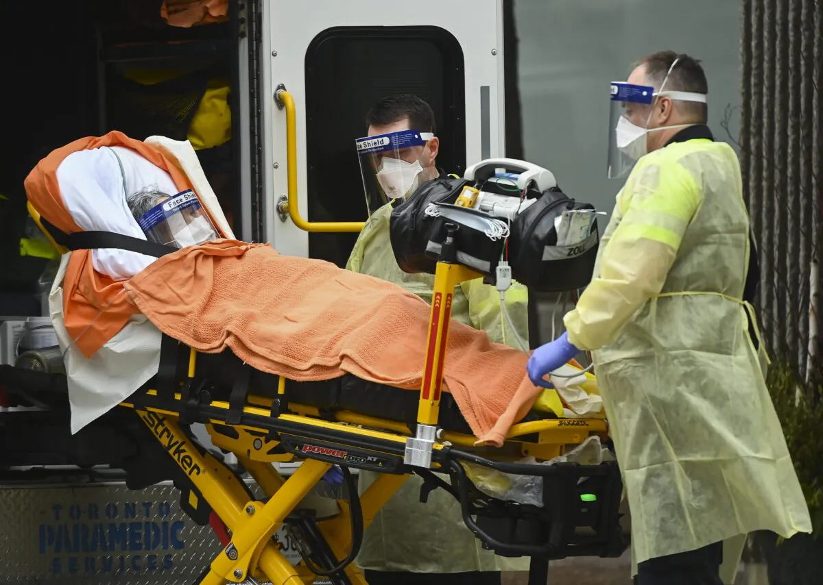 Paramedics take away an elderly patient at the Tendercare Living Centre, long-term-care facility during the COVID-19 pandemic in Scarborough, Ont., Canada on Dec. 23, 2020. (Nathan Denette/The Canadian Press)