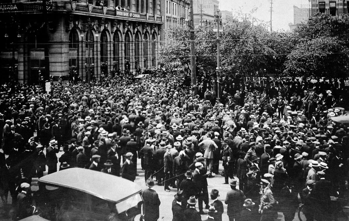 A crowd gathers outside the Union Bank of Canada building on Main Street during the Winnipeg General Strike on June 21, 1919. The six-week strike of more than 30,000 workers brought economic activity to a standstill in Winnipeg, at the time Canada's third-largest city. (The Canadian Press/National Archives of Canada)
