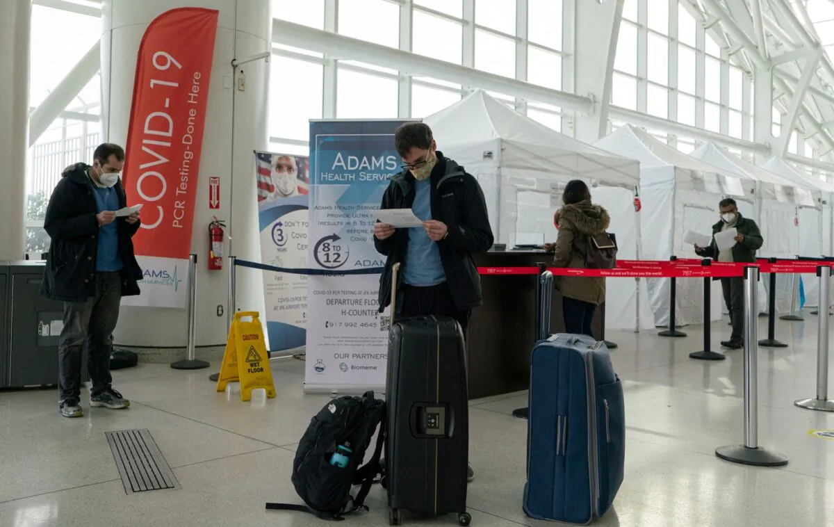 Travelers look at COVID-19 results after being tested inside JFK International airport in New York on Dec. 22, 2020. (Kena Betancur/AFP via Getty Images)