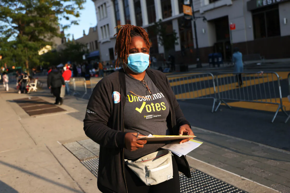 Natasha Cherry-Perez, senior associate director of community engagement with Uncommon Schools, walks the streets as she helps people register to vote on Sept. 22, 2020, in the Crown Heights neighborhood of Brooklyn. (Michael M. Santiago/Getty Images)