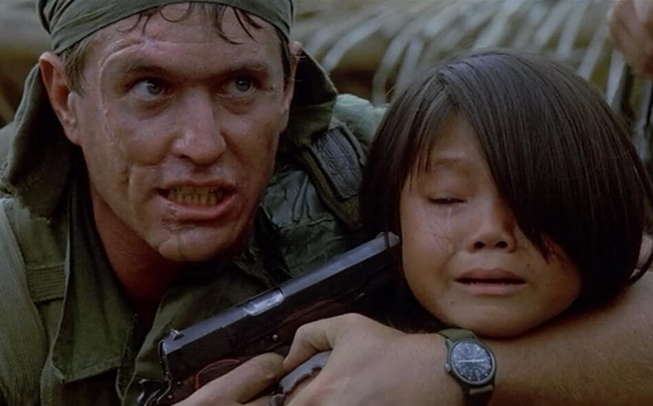 man holds pistol to young girl's head in "Platoon"