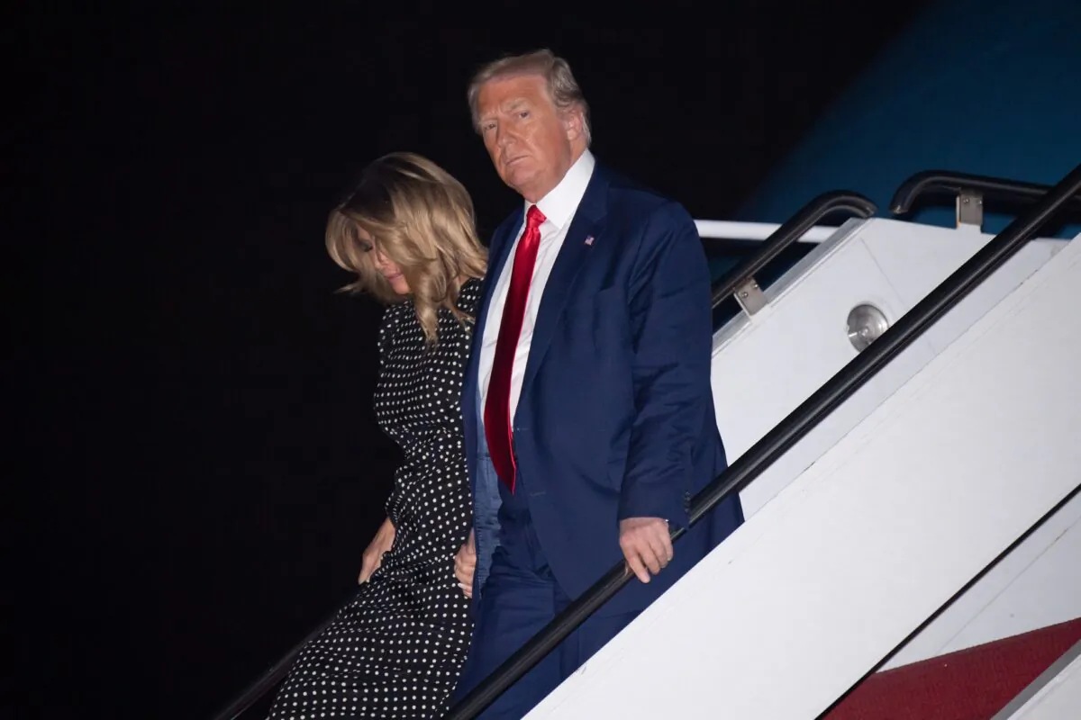 President Donald Trump and First Lady Melania Trump disembark from Air Force One upon arrival at Palm Beach International Airport in West Palm Beach, Fla., on Dec. 23, 2020. (Saul Loeb/AFP via Getty Images)
