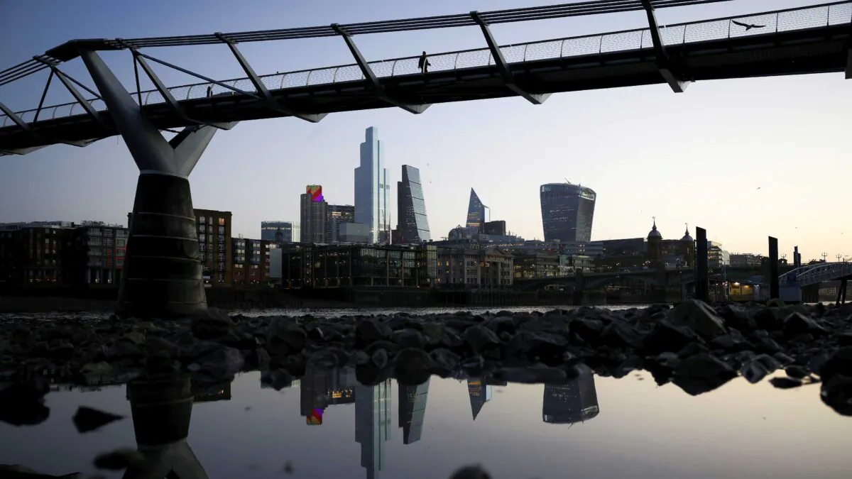 The financial district can be seen as people walk across Millennium Bridge in London, Britain, on Dec. 14, 2020. (Henry Nicholls/Reuters)