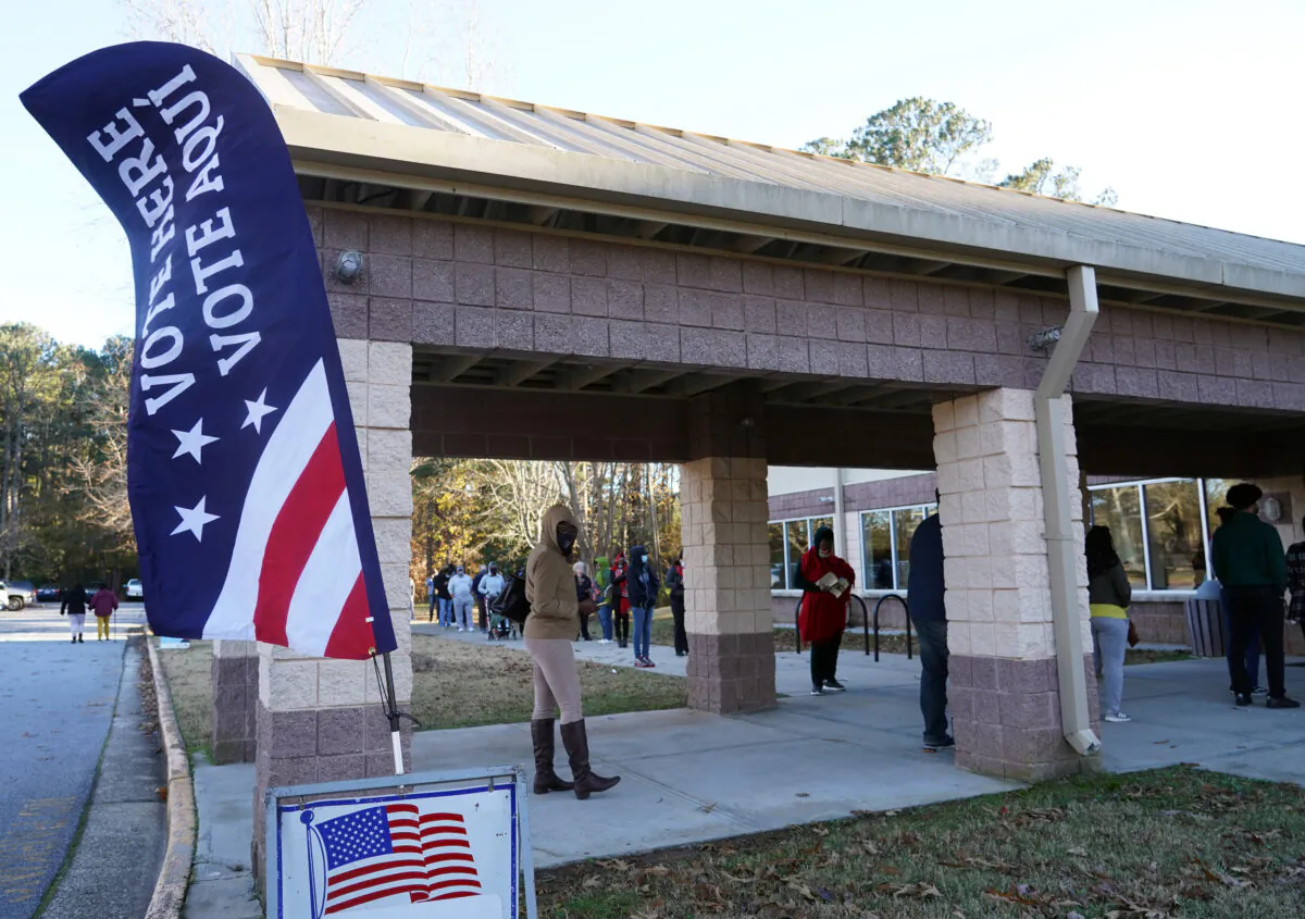 Voters stand in line to cast their ballots during the first day of early voting in the U.S. Senate runoffs at Lenora Park in Atlanta, Ga., on Dec. 14, 2020. (Tami Chappell/AFP via Getty Images)