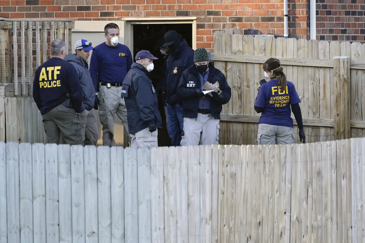 FBI and ATF agents search the basement of a home in Nashville, Tenn., on Dec. 26, 2020. (Mark Humphrey/AP Photo)