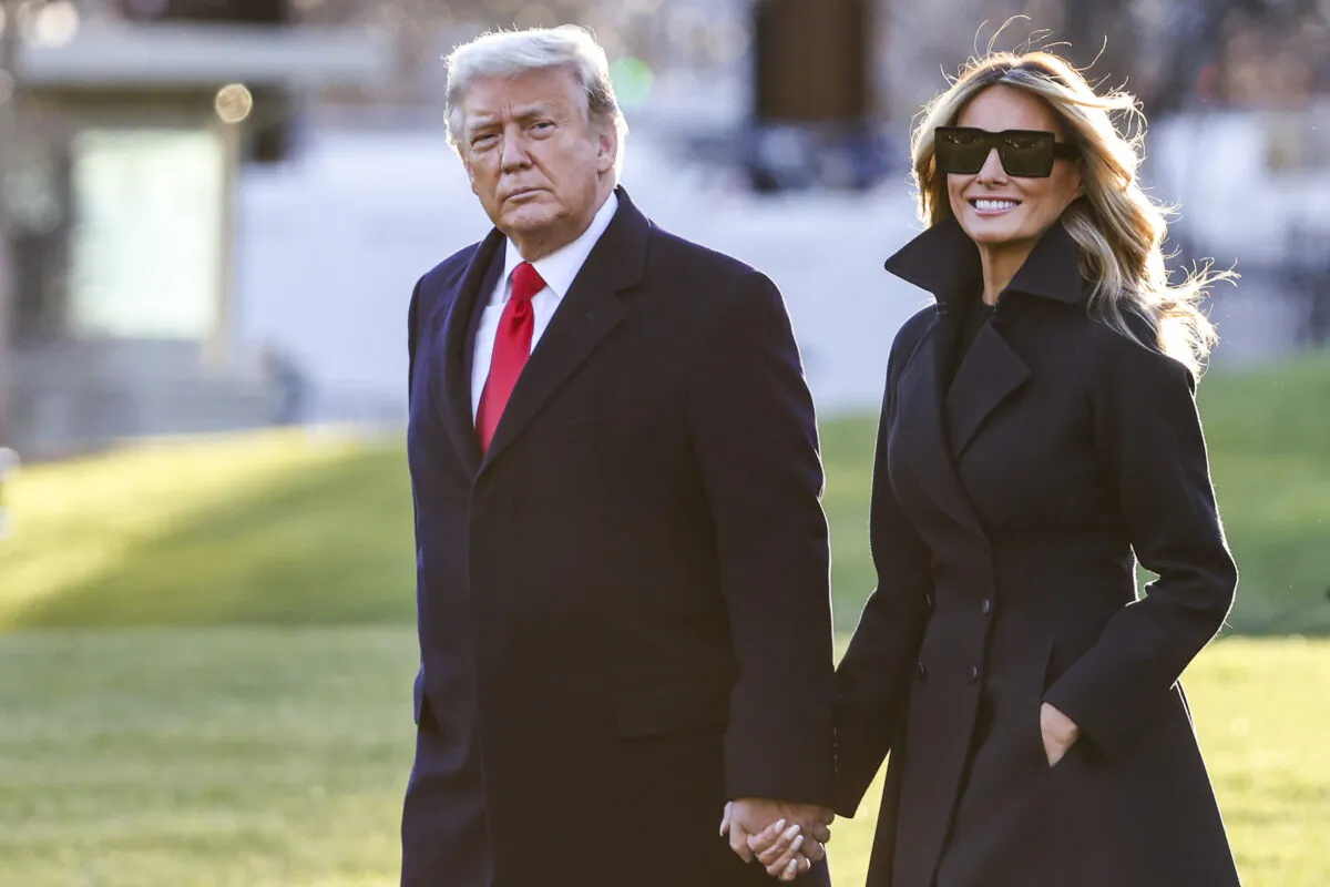 Then-President Donald Trump and then-first lady Melania Trump walk on the south lawn of the White House in Washington on Dec. 23, 2020. (Tasos Katopodis/Getty Images)