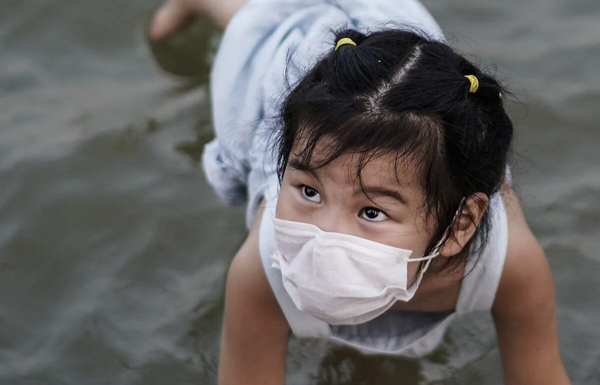 A girl plays in a flooded Jiangtan park in Wuhan, China on June 30, 2020. (Getty Images)