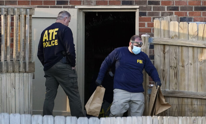 FBI and ATF agents investigate a home connected to the Christmas Day bombing, in Nashville, Tenn., on Dec. 26, 2020. (Mark Humphrey/AP Photo)