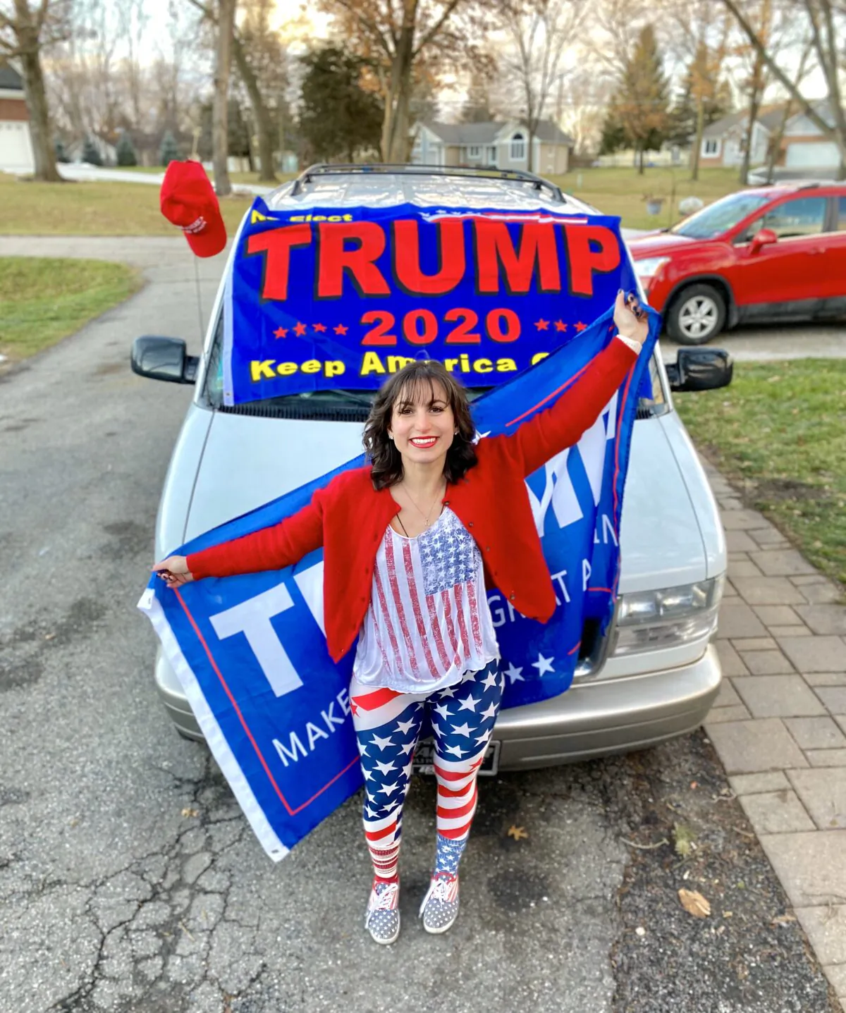 Amelia, 22, of Fenton, Michigan, poses for a photo in front of a car decorated with a Trump flag. (Courtesy Photo)