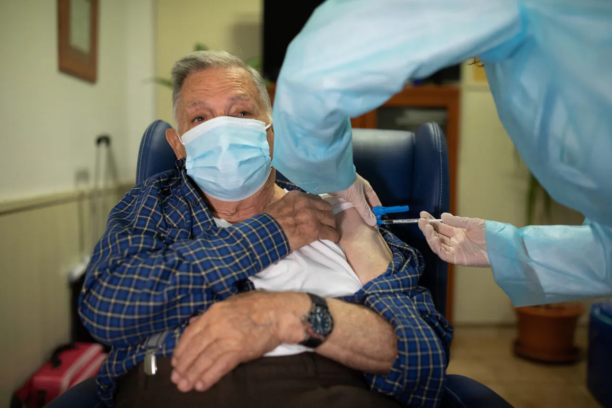 In this handout photo, José Bruballa, 86, receives one of the first Pfizer/BioNTech Covid-19 vaccines in Spain at the Somontano nursing home on Dec. 27, 2020 in Barbastro, Spain. (Alvaro Calvo/Government of Aragon via Getty Images)