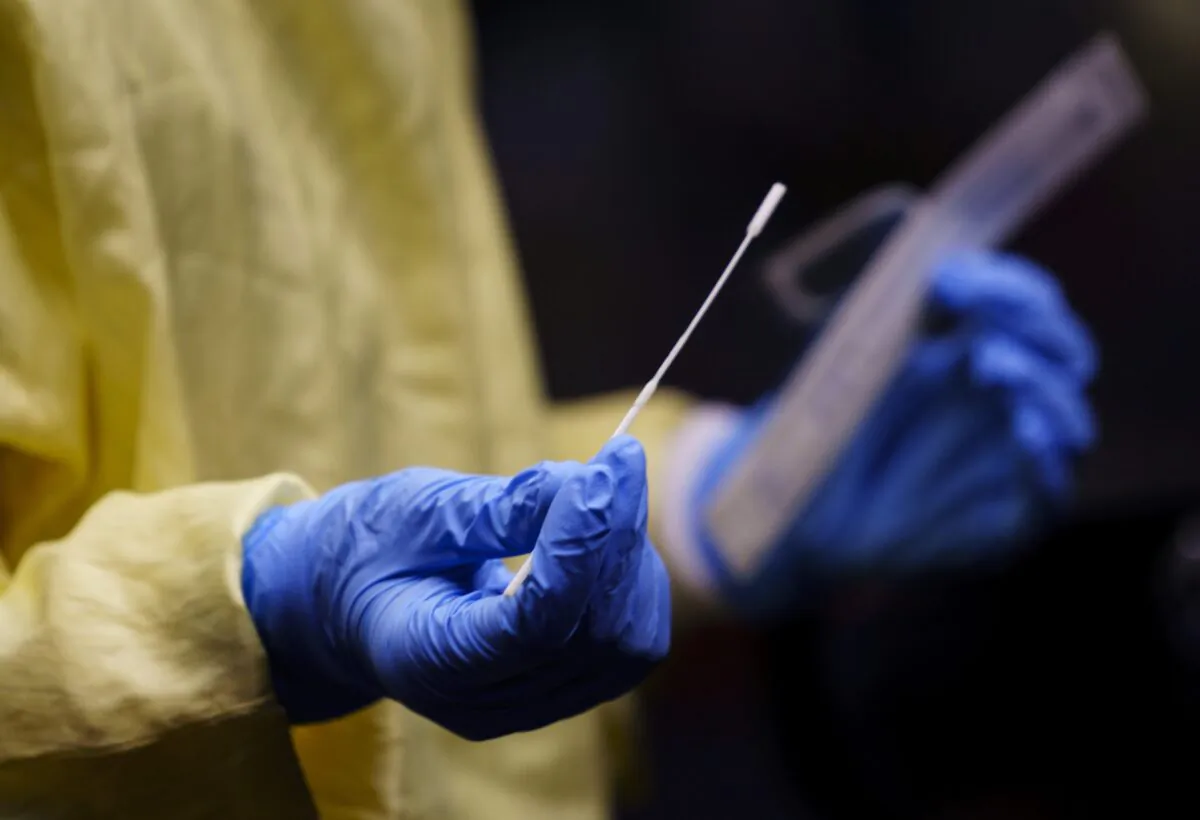 A nurse gets a swab ready to perform a test on a patient at a drive-in COVID-19 clinic in Montreal, on Oct. 21, 2020. (The Canadian Press/Paul Chiasson)
