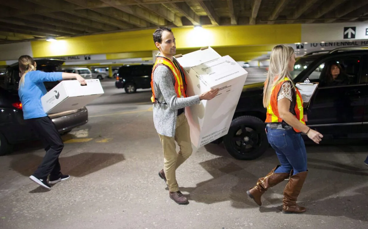 Election workers unload ballot boxes at City Hall in London, Ont., during the Ontario municipal elections on Oct. 22, 2018. (The Canadian Press/ Geoff Robins)