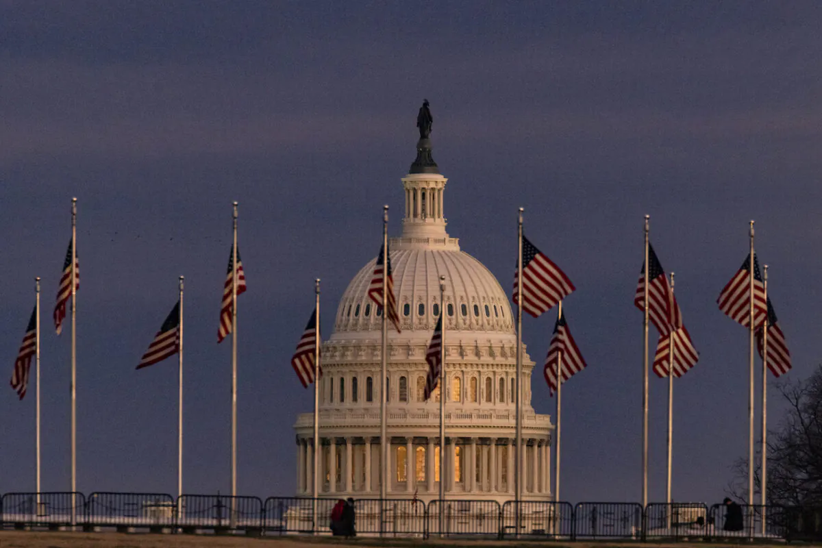 The U.S. Capitol Building is seen past the Washington Monument as the sun sets in Washington on Dec. 26, 2020. (Samuel Corum/Getty Images)