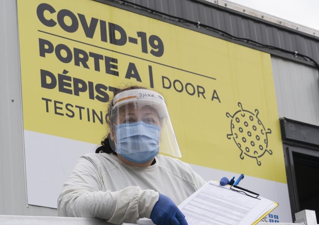 A nurse waits for patients at a COVID-19 test clinic in Montreal, on Dec. 11, 2020. (THE CANADIAN PRESS/Paul Chiasson)