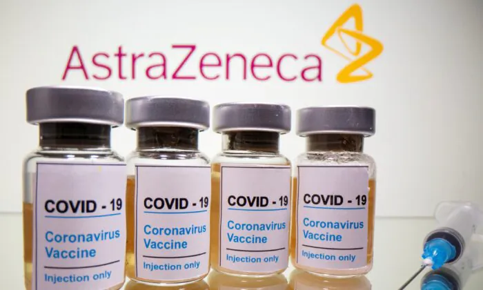 Vials with a sticker reading "COVID-19 / Coronavirus vaccine / Injection only" and a medical syringe are seen in front of a displayed AstraZeneca logo in this illustration taken on Oct. 31, 2020. (Dado Ruvic/Illustration/File Photo/Reuters)