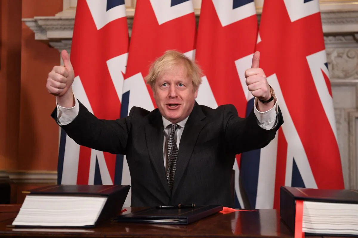 Britain's Prime Minister Boris Johnson gives a double thumbs up after signing the Trade and Cooperation Agreement between the UK and the EU, the Brexit trade deal, at 10 Downing Street in central London on Dec. 30, 2020. (Leon Neal/Pool/AFP via Getty Images)