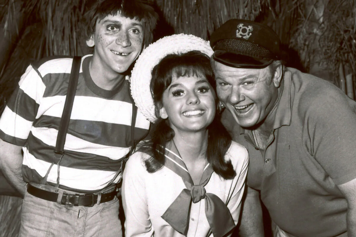 In this 1965 file photo, Dawn Wells, center, poses with fellow cast members of "Gilligan's Island," Bob Denver and Alan Hale Jr., in Los Angeles. Wells, who played the wholesome Mary Ann on the 1960s sitcom "Gilligan's Island," has died. Her publicist says Wells died early Wednesday, Dec. 30, 2020, in Los Angeles, of causes related to COVID-19. (AP Photo/File)