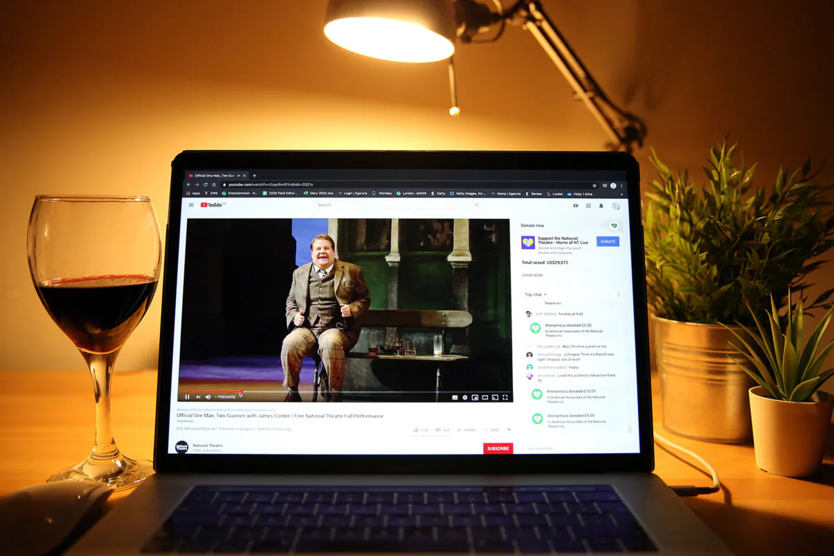 In this photo illustration, James Corden is seen on the screen of a laptop streaming "One Man, Two Guvnors" during a "National Theatre at Home" broadcast in London on April 2, 2020. (Simone Joyner/Getty Images)
