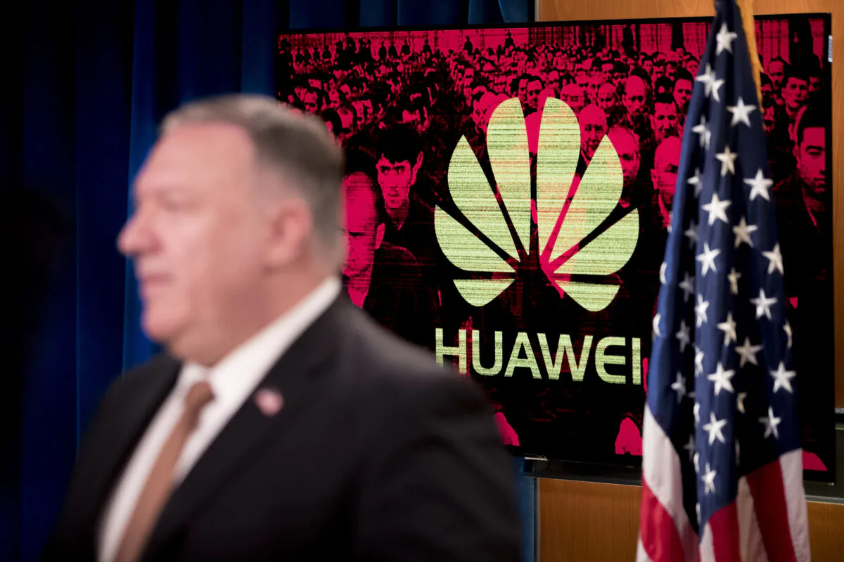 A monitor displays the Huawei logo behind Secretary of State Mike Pompeo during a news conference at the State Department in Washington on July 15, 2020. (ANDREW HARNIK/POOL/AFP via Getty Images)