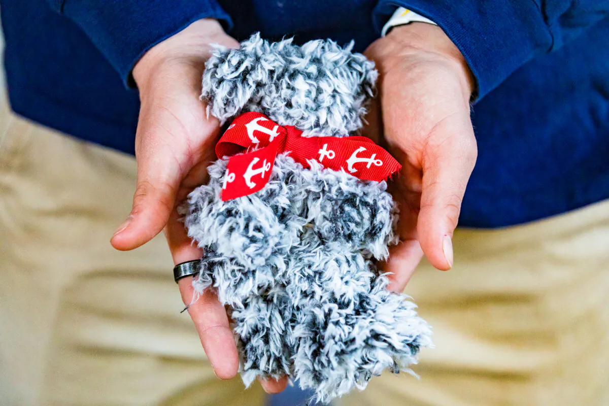 William Pugmire shows a teddy bear he made himself to donate to a hospice, at his home in Carlsbad, Calif., on Dec. 29, 2020. (John Fredricks/The Epoch Times)