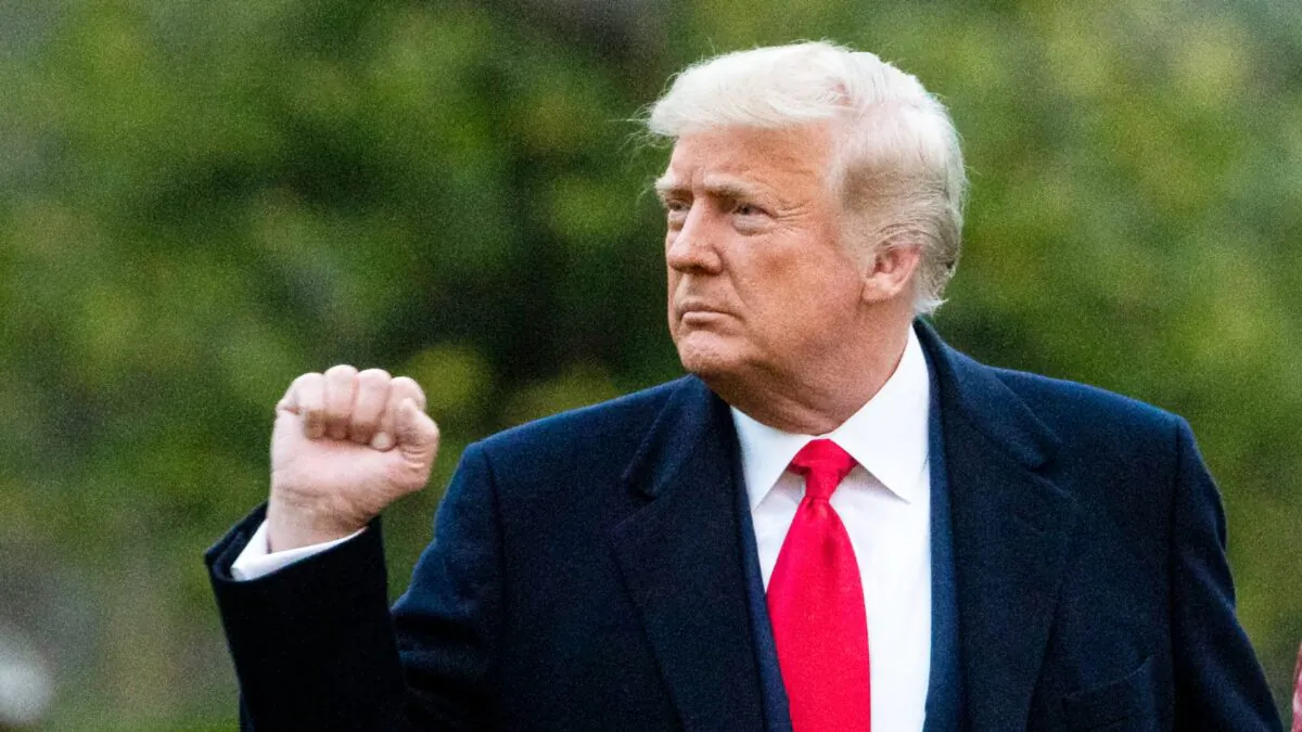 President Donald Trump pumps his fist as he departs on the South Lawn of the White House on Dec. 5, 2020. (Al Drago/Getty Images)