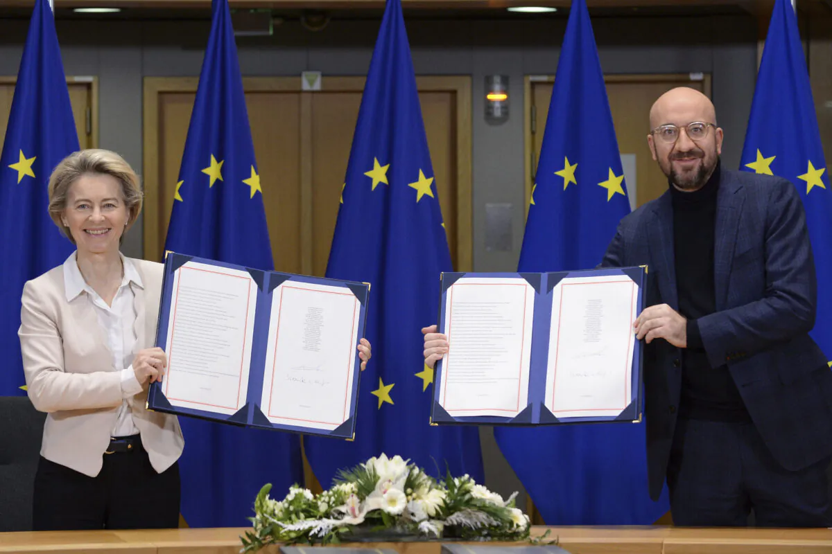 European Commission President Ursula von der Leyen and European Council President Charles Michel show signed EU-UK Trade and Cooperation Agreements at the European Council headquarters in Brussels on Dec. 30, 2020. (Johanna Geron/Pool Photo via AP)
