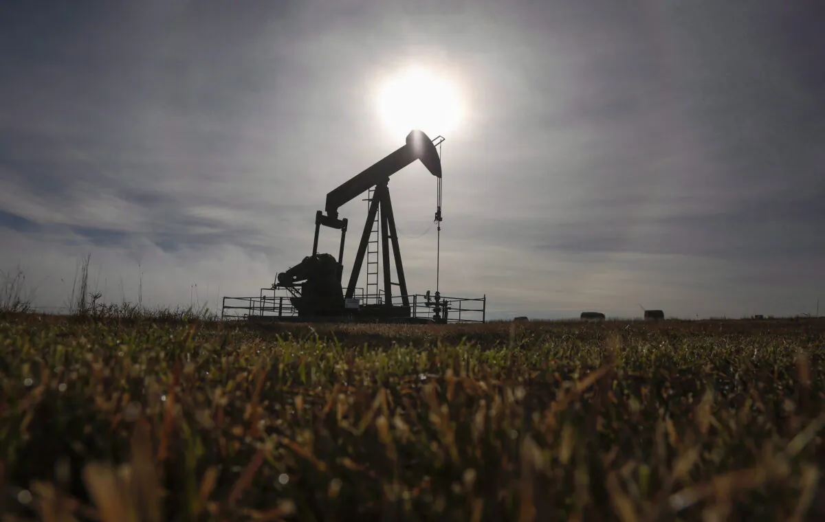 A pumpjack works at a well head on an oil and gas installation near Cremona, Alta., in a file photo. (Jeff McIntosh/The Canadian Press)