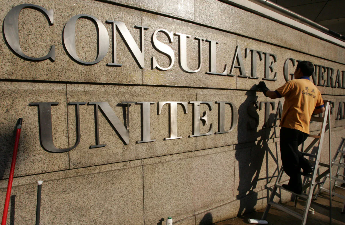 A worker cleans the front wall of the United States Consulate General in Hong Kong on Dec. 17, 2005. (Claro Cortes IV/File Photo/Reuters)