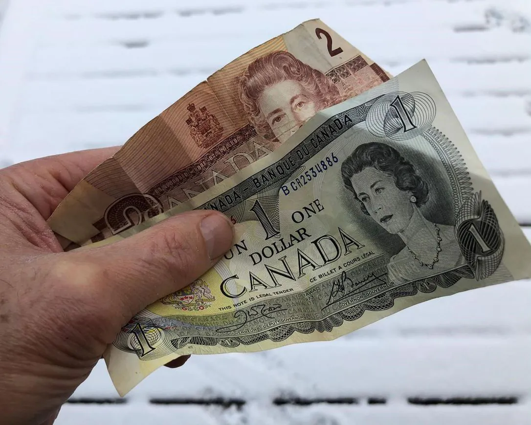 Old one and two dollar bills are shown in Oakville, Ont. on Dec. 30, 2020. (The Canadian Press/Richard Buchan)