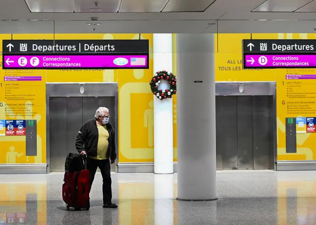 A man makes his way through Pearson International Airport during the COVID-19 pandemic in Toronto on Dec. 14, 2020. (The Canadian Press/Nathan Denette)