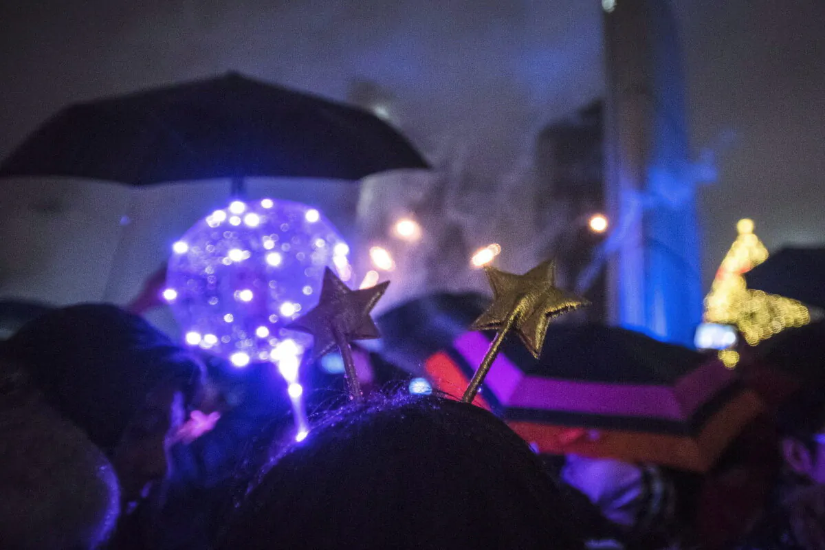 People watch the fireworks during the New Year's Eve celebrations held at Nathan Phillip square in Toronto, Canada, on Jan. 1, 2019. (Tijana Martin/The Canadian Press)