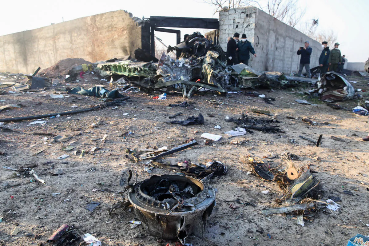 People and rescue teams are pictured amid the wreckage after a Ukrainian plane carrying 176 passengers crashed near Imam Khomeini airport in the Iranian capital Tehran early in the morning on Jan. 8, 2020, killing everyone on board. (Rouhollah Vahdati / ISNA / AFP via Getty Images) 