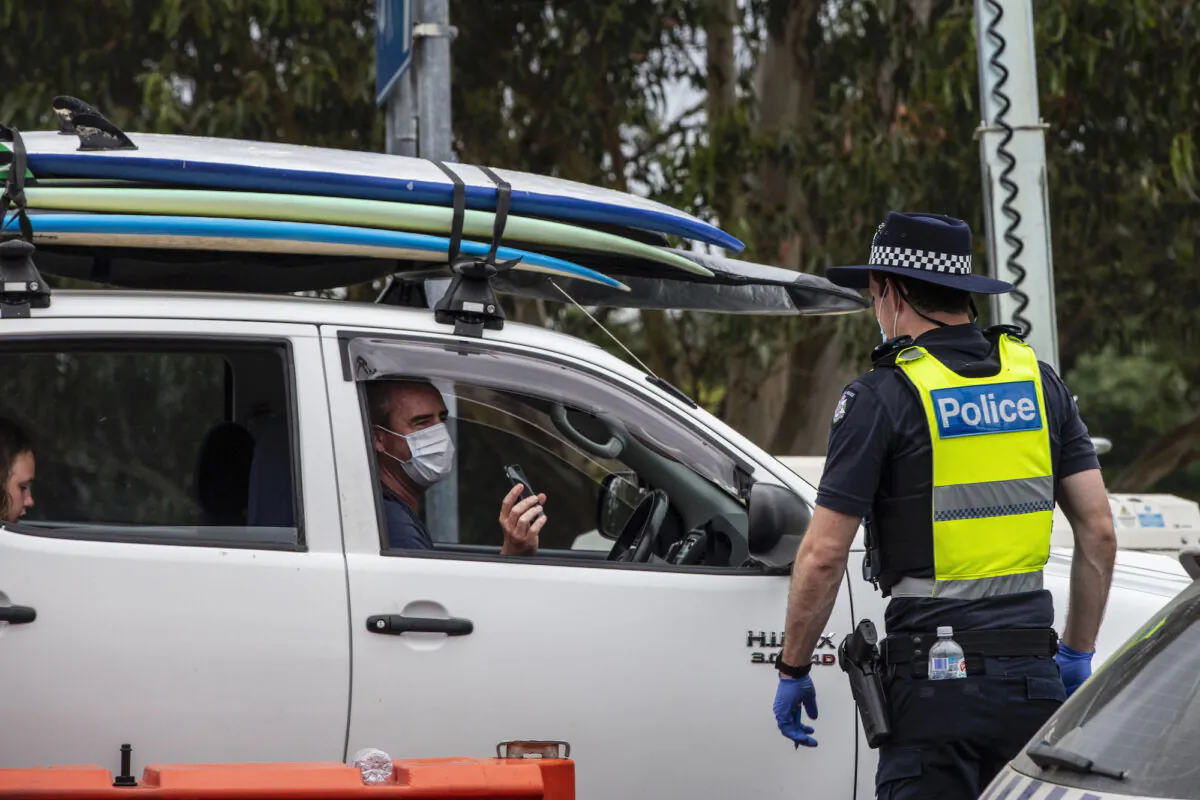 Police officer patrols and checks for entry permits to Victoria at a border checkpoint in Mallacoota, Australia on Dec. 31, 2020. (Diego Fedele/Getty Images)