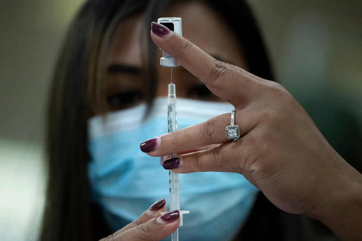 A pharmacist prepares to deliver the Pfizer COVID-19 vaccine in Falls Church, Va., on Dec. 30, 2020. (Brendan Smialowski/AFP via Getty Images)