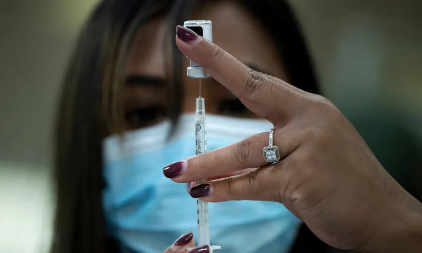 A pharmacist prepares to deliver the Pfizer COVID-19 vaccine in Falls Church, Va., on Dec. 30, 2020. (Brendan Smialowski/AFP via Getty Images)