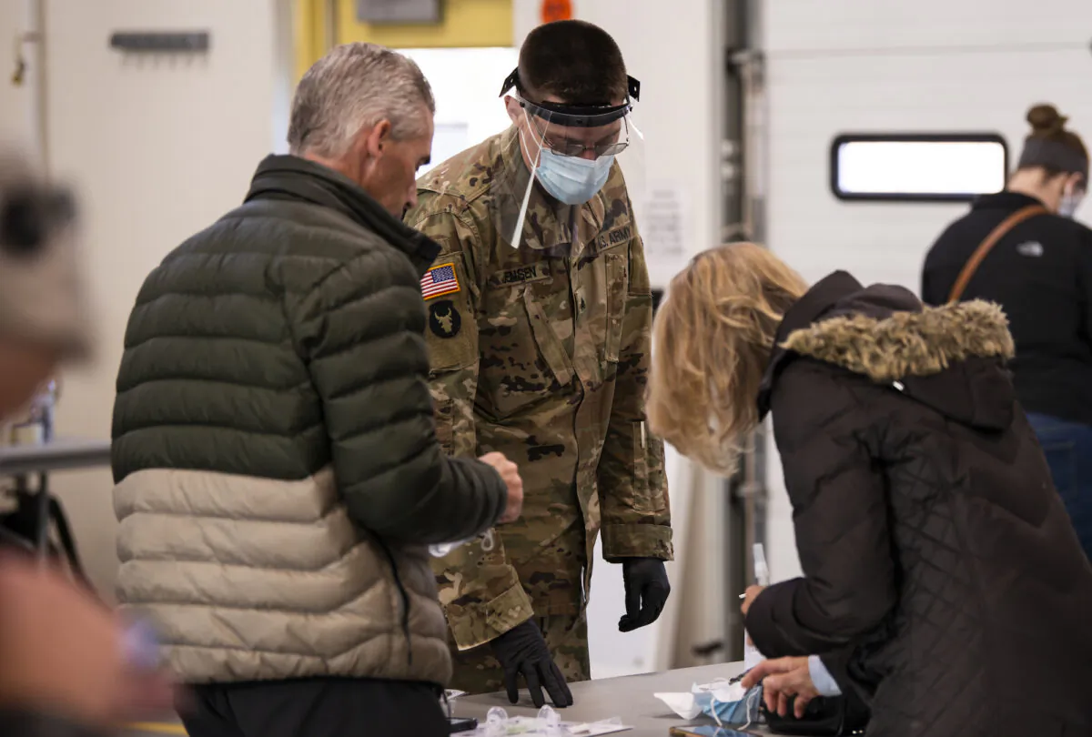 Minnesota National Guard personnel assist residents at a COVID-19 testing facility in the Stillwater Armory National Guard Center in Stillwater, Minn., on Dec. 10, 2020.  (Stephen Maturen/Getty Images)