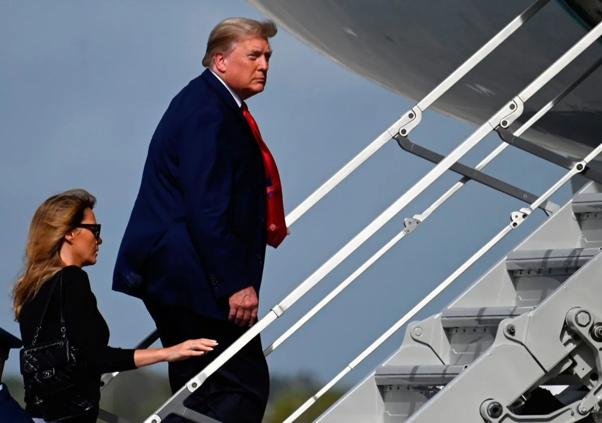 President Donald Trump boards Air Force One with First Lady Melania Trump at Palm Beach International Airport in Fla., on Dec. 31, 2020. (Andrew Caballero-Reynolds/AFP via Getty Images)