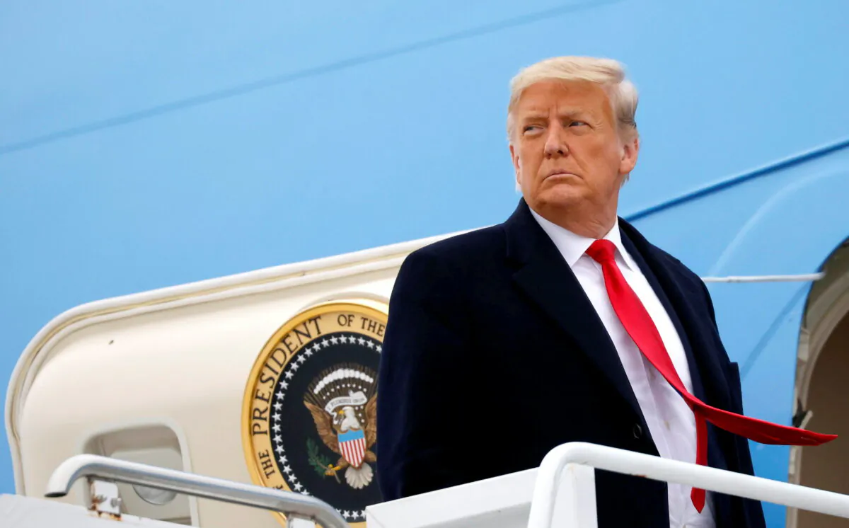 Then-President Donald Trump boards Air Force One at Valley International Airport after visiting the U.S.-Mexico border wall, in Harlingen, Texas, on Jan. 12, 2021. (Carlos Barria/Reuters)